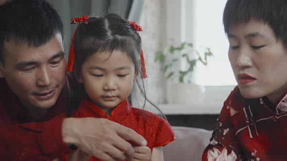 Chinese Family Preparing Gift Basket for Lunar New Year