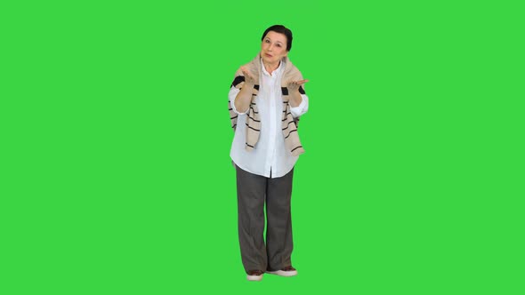 Middle Aged Woman Talking To Camera on a Green Screen, Chroma Key.