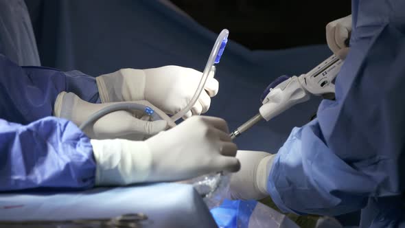 Surgeons working during surgery, close up on hands and instruments.