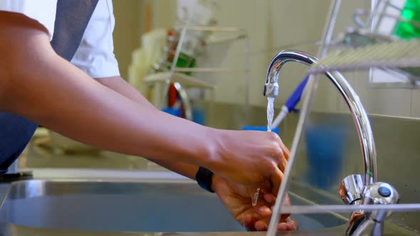 Chef washing hands in sink in kitchen 4k