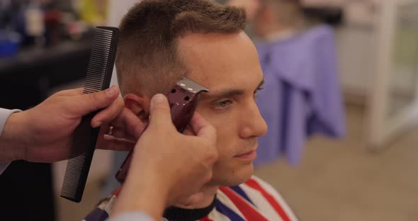 Barber Making Male Haircut in Salon