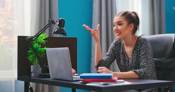 Smiling Student Girl Chats on Video Chat on Laptop