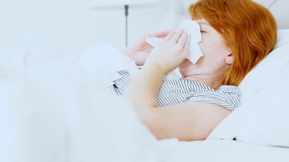 Woman sneezing while sleeping 