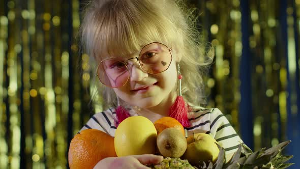 Closeup Shot of Girl in Stylish Sunglasses Posing Looking at Camera with Bunch of Fruits in Hands