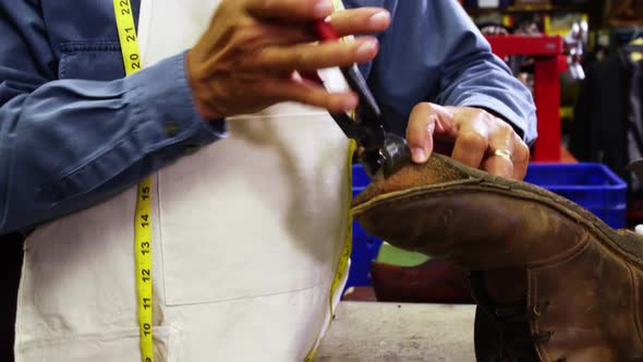 Cobbler repairing a shoe