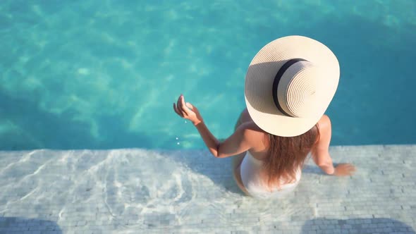 Young asian woman enjoy around outdoor swimming pool for leisure