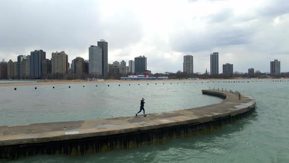 lifestyle fitness and sports person running in lake shore of lake michigan in chicago