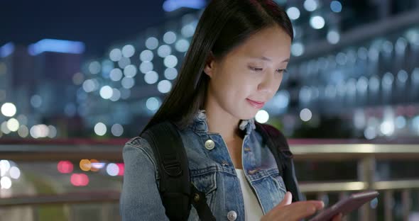 Woman look at the cellphone in city at night