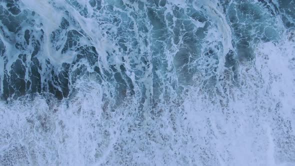 Amazing Waves with White Foam Roll on Clean Sand Upper View