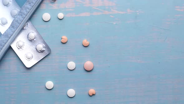  White Pills and Blister Pack on Blue Background 