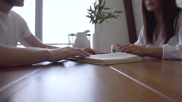 A man and a woman are discussing a book