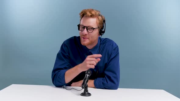 Man Recording Podcast in Blue Studio