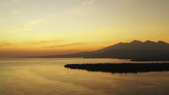 Romantic sunset over the Gilli Islands, Bali, Indonesia. Cinematic aerial seascape, golden colored s