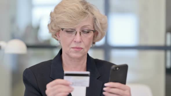 Portrait of Old Businesswoman with Successful Online Shopping on Smartphone