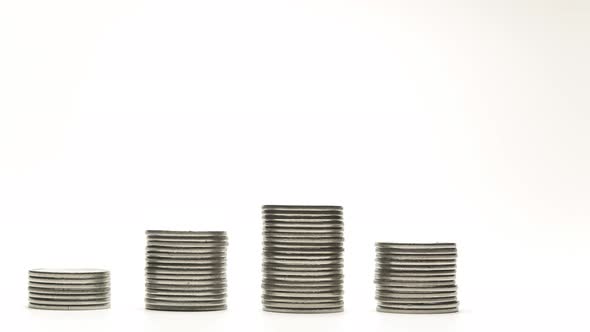 Silver Coins on Stacks Are Increase and Decrease on White Background Stop Motion Animation