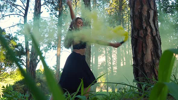 Young female professional dancer performing in forest