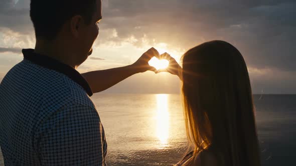 Couple Holding Hands in a Heart Shape