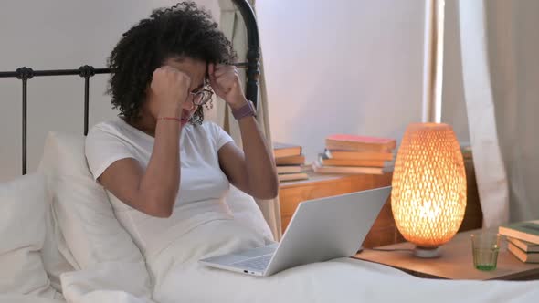 African Woman with Laptop Having Loss in Bed