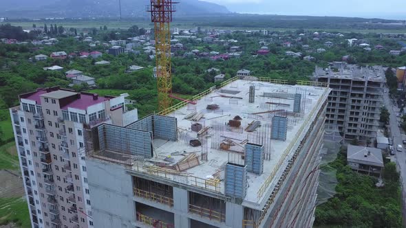 Drone view of a multi-storey building under construction with a tower crane