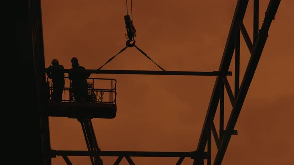 Workers are Assembling a Metal Frame for the Roof of an Industrial Building