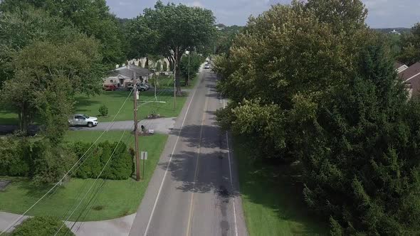 drone rises to show suburban town