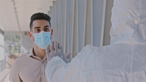 Hispanic Man Wears Face Mask Walking Through Airport Indoor in Shopping Center Unrecognizable Worker