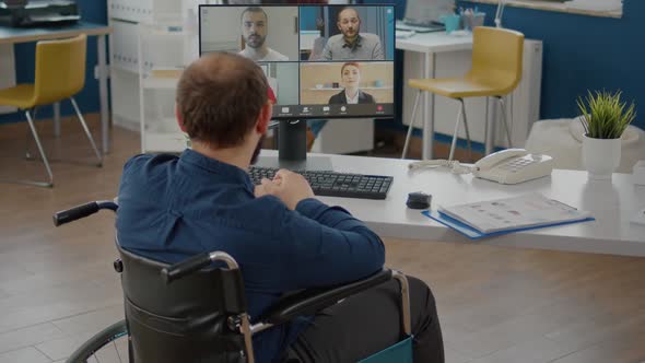 Handicapped Paralysed Invalid Manager Talking with Team on Videocall