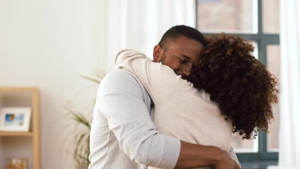 Happy African American Couple Hugging at Home