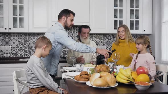 Happy Family Gethering Together at the Festive Table to Celebrate Thanksgiving Day