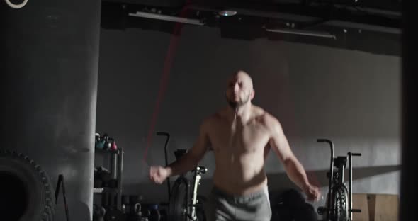 Shirtless Sportsman Jumping Rope During Training in Gym