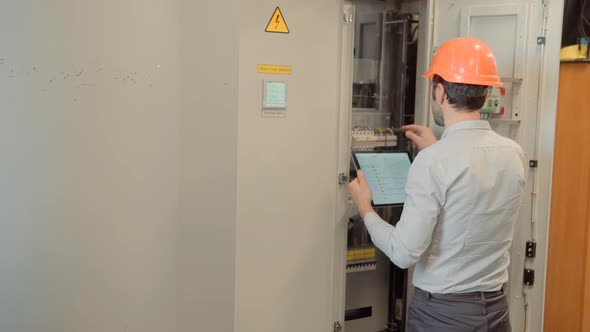 Electric Engineer Checking Power Voltage In Network Circuit Breaker. Power Electric Line.