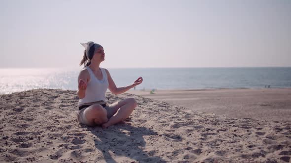 Attractive Woman Meditating at Beach at Seashore, Woman Practicing Yoga