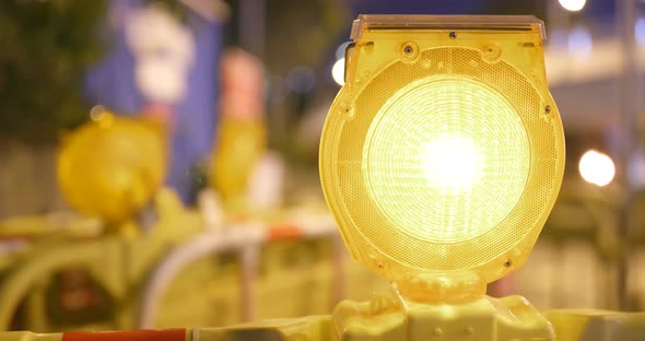 Warning light in yellow in construction site at night