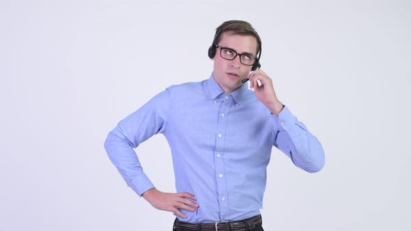 Young Stressed Businessman As Call Center Representative Looking Annoyed