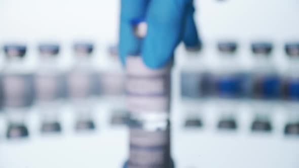 Close up, Scientist is holding a glass vial for vaccine in laboratory.