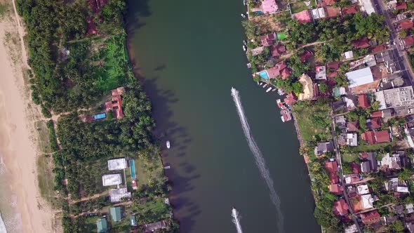 Aerial view. motorized fishing boat floats on a river surrounded by palm trees