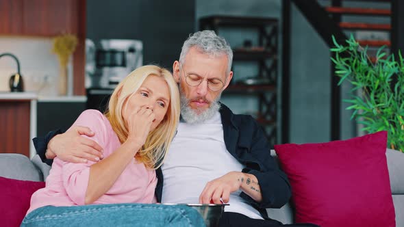 Close Up of Married Couple Have a Fan Sitting on the Couch and Watching a Movie