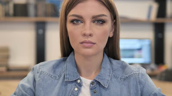 Young Woman in Office Looking at Camera