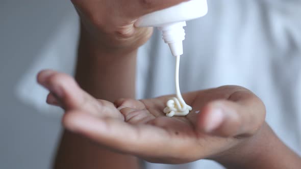 Man Using a Sunscreen Cream Close Up