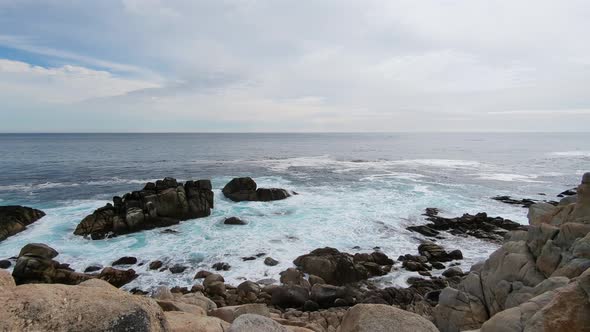 Blue ocean waves hitting rocks at Monterey Beach, 17 mile Drive Spanish bay in Monetery, California.