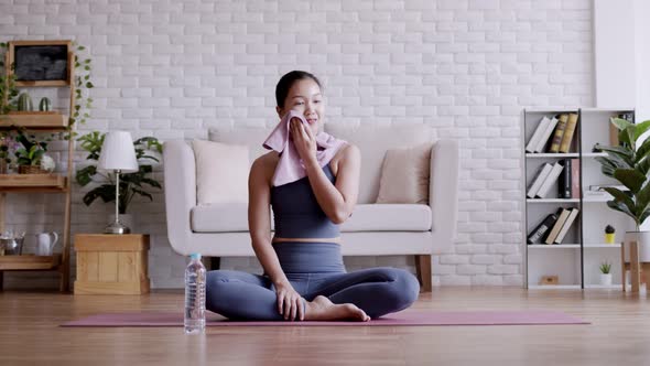 Asian woman drinking fresh water after pilates exercise yoga.