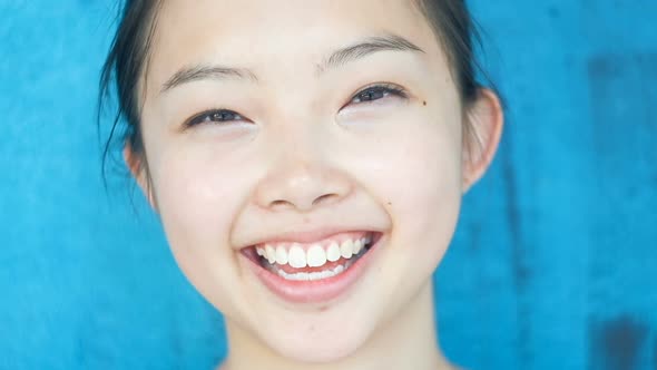 Beautiful Girl with Black Hair and Cheerful Smile Closeup