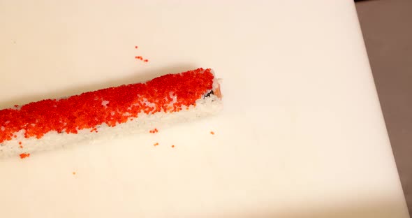 Chef Making Sushi Rolls With Red Caviars. - high angle shot