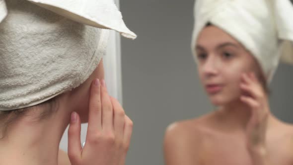 Woman in Towel Discovering Pimple