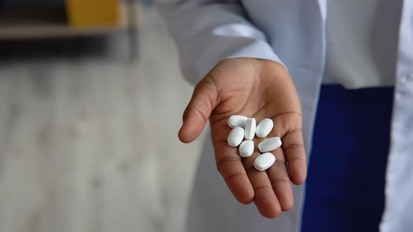 Young Indian Woman Doctor Holds Pills in Hand