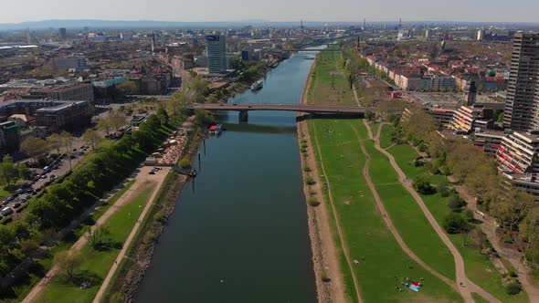 Top view of the embankment of the Neckar River. Bridges, TV tower, green grass and trees.
