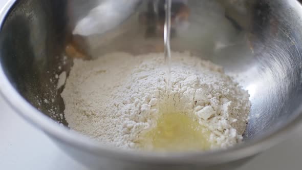 Falling Egg Into Bowl with Flour.