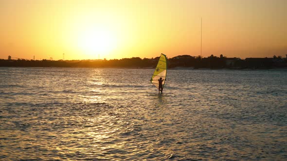 Surfing Man is on a Surfboard Floating on the Water