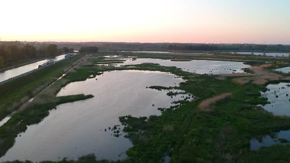 River Schelde and flooded area of land, fly over drone view perspective
