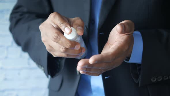 Close Up of Young Man Hand Using Hand Sanitizer Spray